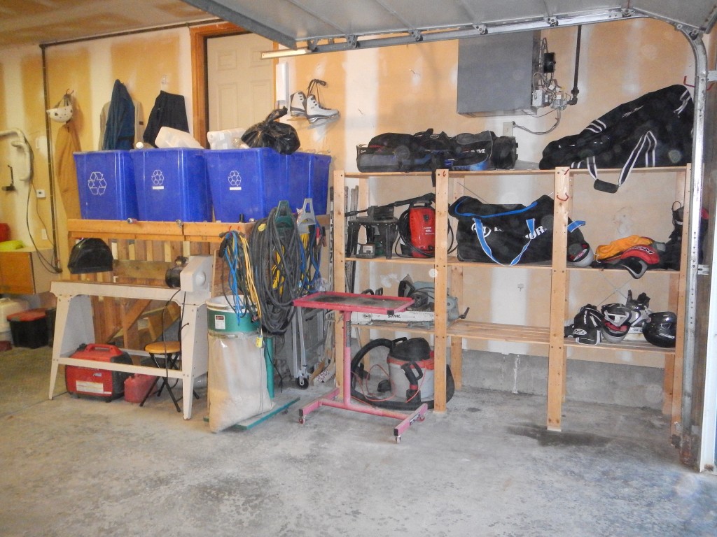 The lathe is tucked away but accessible!! He even cleared enough space to use as a drying rack for hockey gear!